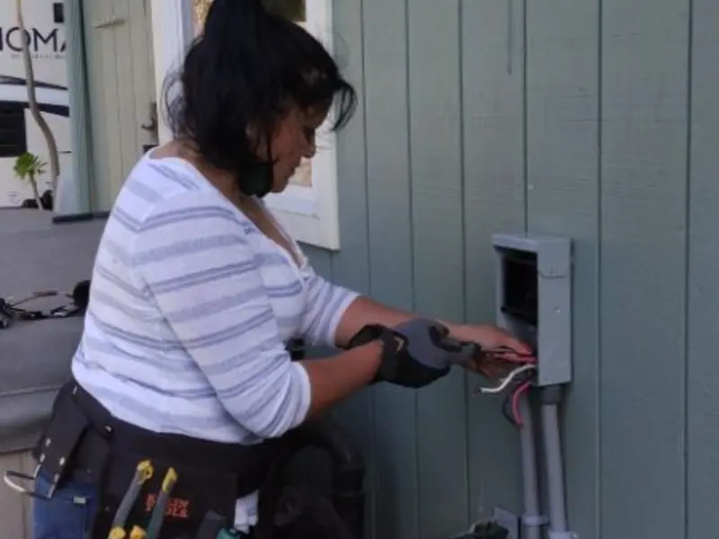 Licensed electrician wiring an exterior subpanel in Pepperdine University